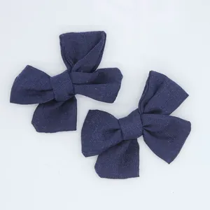 Close-up of dark blue linen bows for DIY baby hair accessories and sock decorations