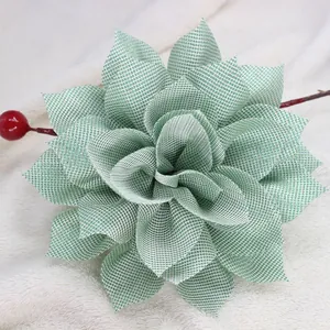 Macro detail of checkered fabric flower hair clip with a small red berry accent