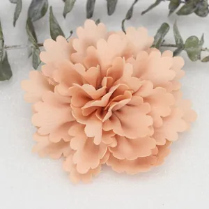 Detail of 7cm peach wavy satin fabric flower with delicate layered petals for DIY crafts