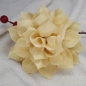 Close-up of golden sparkling floral hair clip on white faux fur with red berries decor