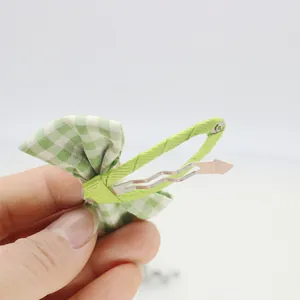Detalle de pinza para el pelo con lazo de cuadros verdes y blancos y clip BB forrado