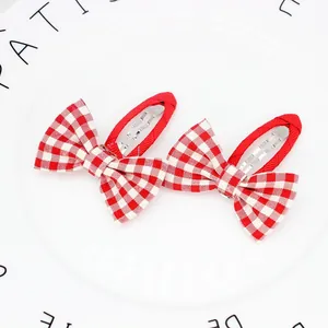 Detalle de lazos para el pelo en cuadros vichy rojos con clips de metal forrados