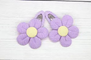 Close-up of cute purple sunflower hair clips with soft fabric petals for little girls