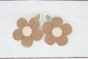 Detailed view of children flower hair clips featuring houndstooth pattern and soft fabric petal