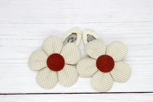 Close-up of handmade floral hair clips with beige gingham petals and burgundy centers