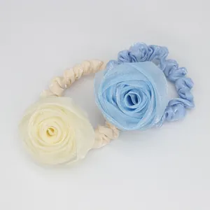 Elegant rose flower hair ties in light blue and yellow fabric for women hairstyles