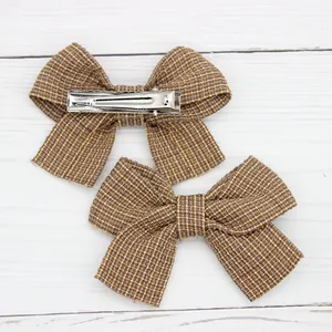 Detail of vintage striped bow hair clips showing front fabric and silver metal alligator clip