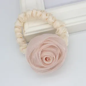 Elegant large fabric rose hair tie in soft pink organza for women's hairstyles