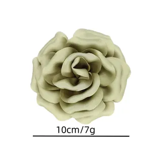 Detail of 10cm olive green satin fabric rose brooch for elegant suit accessory
