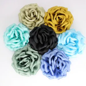 Macro detail of multi-layered 10cm satin handmade peony flowers in seven vibrant colors