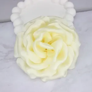 Macro detail of creamy yellow satin fabric flower with delicate layered petals craft