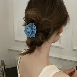 Detail of blue denim rose hair tie worn in an elegant Korean style updo hairstyle