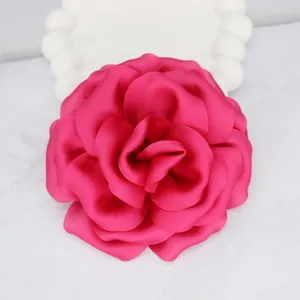 Detailed close-up of a handmade 10cm magenta silk rose with realistic layered fabric petals