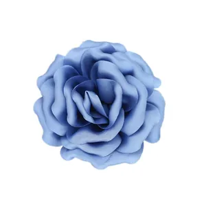 Detail of 10cm dusty blue satin fabric rose brooch with elegant layered flower petals