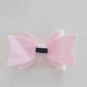 Close-up detail of pink glitter bow straw topper with double-layered ribbon design