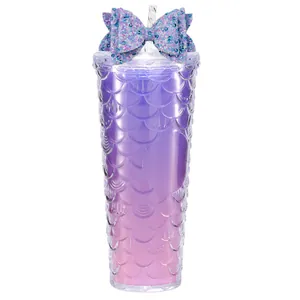 Glitter bow tumbler with purple mermaid scale texture and transparent straw on white background