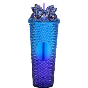 Close-up of a gradient blue studded tumbler with a dark blue sequin bow decoration