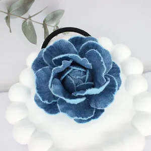 Detail of vintage denim camellia hair tie flower petals and black elastic band