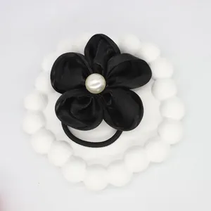 Elegant black fabric flower hair scrunchie with white pearl center for ponytail