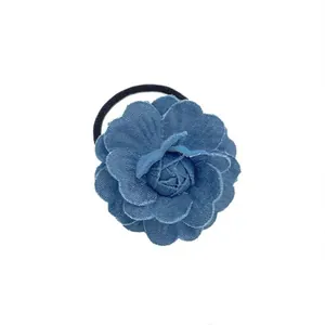 Retro denim camellia flower hair scrunchie in blue fabric with distressed edges