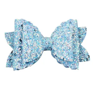 Detail of light blue glitter bow with shimmering sequins and wavy layered design
