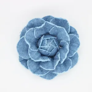 Detailed close-up of handmade denim camellia flower showing layered fabric textures