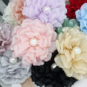 Detailed macro view of delicate multilayer organza peony flowers with pearl center