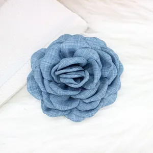 Elegant 9cm light blue denim fabric rose brooch and hair clip on a soft white plush surface