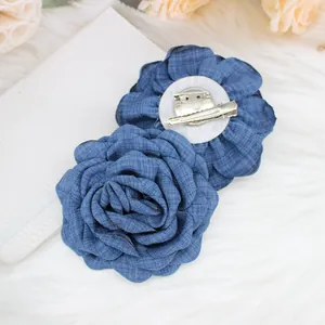 Detail of 9cm denim blue fabric rose brooch and hair clip with metal safety pin and grip