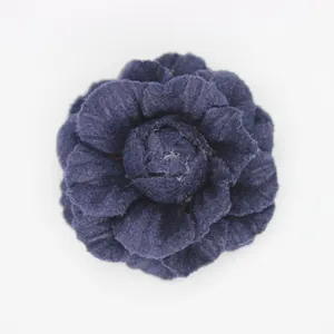 Close-up of deep purple denim camellia flower hair accessory with multi-layer petals