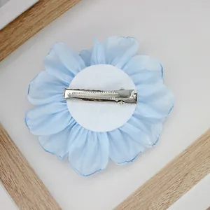 Detail of light blue chiffon peony hair clip with pearl and silver metal alligator clip