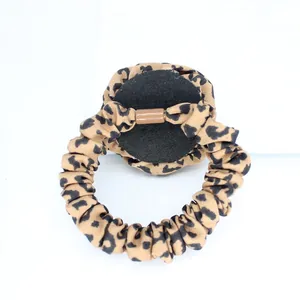 Detailed back view of leopard print scrunchie featuring fabric pleats and round base