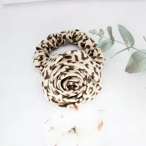 Vintage leopard print scrunchie with a large fabric rose flower for hair styling