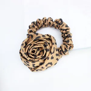 Vintage leopard print rose hair scrunchie with soft fabric texture on white background