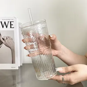 Detailed view of heat-resistant hammer pattern glass cup with straw and lid