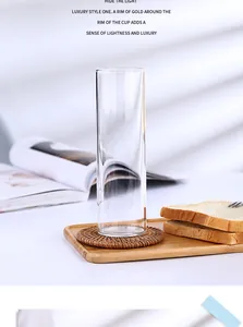 Vue détaillée d'un grand verre Collins sur un dessous de verre en rotin avec texture claire