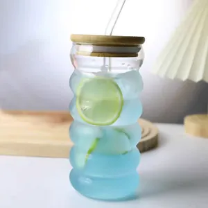 Close-up of ripple glass cup with bamboo lid and straw featuring a lemon slice drink