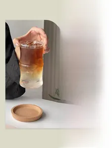 Detail of bamboo shaped borosilicate glass cup with layered coffee on a cork coaster