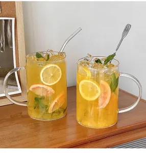 Macro view of 1000ml glass mug with handle, reusable glass straw and stainless steel stirrer