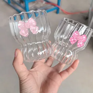 Detailed view of wave-textured glass cup with stylish pink bow-knot decoration