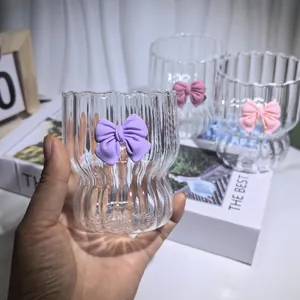 Detail showing ribbed glass coffee mugs with pink and purple decorative bows