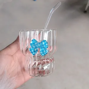 Retro aesthetic glass tumbler with straw featuring pleated ripples and a blue ribbon bow