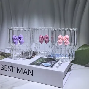 Macro detail of vertical striped glassware with colorful 3D bow accents and clear texture