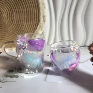 Double-wall insulated glass mugs with colorful feathers and decorative pearls and handles