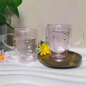 Detailed view of heat-resistant double-wall glass mug with pink dried flower petals