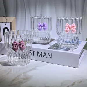 Heat-resistant ribbed glass coffee cup with 3D pink bow and wavy rim design