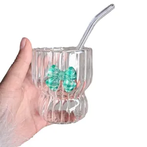 Pink striped glass tumbler with green checkered bow and glass straw for women
