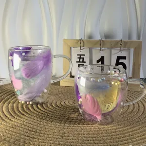 Detail of double-walled glass mugs with colorful feathers and beads in the interlayer