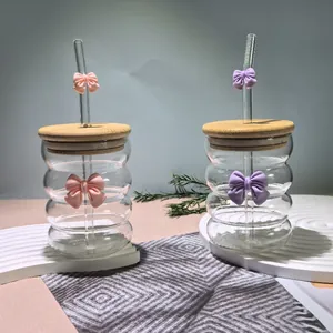 Detailed view of ripple glass cup with pink and purple bow knots and bamboo lid