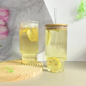 Detailed close-up of ribbed texture glass tumbler set with bamboo lid and straw